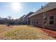 Large backyard features a lawn, wooden fence, and a brick house with windows, providing a serene outdoor space at 2733 Madison Mae Ln, Grayson, GA 30017
