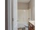 Bright bathroom featuring a shower-tub combo, single sink vanity, and tiled flooring at 2733 Madison Mae Ln, Grayson, GA 30017