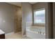 Bright bathroom with a soaking tub and a tiled shower provides a relaxing and stylish space at 2733 Madison Mae Ln, Grayson, GA 30017