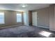 Bedroom featuring neutral carpet, natural light, and two closets at 2733 Madison Mae Ln, Grayson, GA 30017