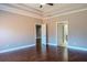 Open bedroom with hardwood floors has doors leading to other rooms, creating an easy flow throughout the house at 2733 Madison Mae Ln, Grayson, GA 30017