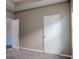 Neutral-toned bedroom with carpet, featuring a doorway and closet door for ample storage at 2733 Madison Mae Ln, Grayson, GA 30017