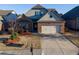 Charming single-Gathering home with a brick and gray facade, a well-manicured lawn, and an attached two-car garage at 2733 Madison Mae Ln, Grayson, GA 30017