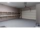 Clean garage with epoxy flooring and shelving for storage at 2733 Madison Mae Ln, Grayson, GA 30017