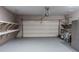 Clean garage with epoxy flooring and shelving for storage at 2733 Madison Mae Ln, Grayson, GA 30017