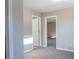 Hallway with neutral carpet, fresh paint, and two access doorways at 2733 Madison Mae Ln, Grayson, GA 30017