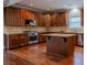 Open kitchen with stainless steel appliances, granite countertops, and hardwood flooring at 2733 Madison Mae Ln, Grayson, GA 30017