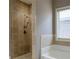 Tiled shower and tub in a serene bathroom setting offer a spa-like experience within your own home at 2733 Madison Mae Ln, Grayson, GA 30017