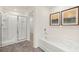 Bathroom featuring a bathtub with shower and view of the walk-in closet at 305 Sound Cir, Stockbridge, GA 30281