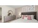 Comfortable bedroom featuring a stylish dresser, mirror and padded headboard at 305 Sound Cir, Stockbridge, GA 30281
