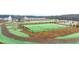 Expansive fenced dog park area with a walking path in a manicured green space at 305 Sound Cir, Stockbridge, GA 30281