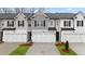 Charming townhomes feature modern design, white garages, and dark shutters for striking curb appeal at 305 Sound Cir, Stockbridge, GA 30281