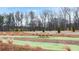 Well-manicured park-like green space with a bench perfect for relaxing outdoors at 305 Sound Cir, Stockbridge, GA 30281