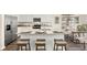Modern kitchen features stainless steel appliances, granite countertops, and center island with bar stool seating at 305 Sound Cir, Stockbridge, GA 30281