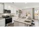 Open concept kitchen featuring granite countertops, stainless steel appliances, and a large center island with bar stool seating at 305 Sound Cir, Stockbridge, GA 30281