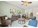 Well-lit living room showcasing the furniture and decor, with an open view to the staircase at 305 Sound Cir, Stockbridge, GA 30281
