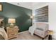 Main bedroom sitting area with a chair, lamp, side table, and artwork at 305 Sound Cir, Stockbridge, GA 30281