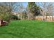 Expansive grassy backyard, partially shaded by trees at 4345 Settlers Grove Rd, Cumming, GA 30028