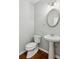 Clean bathroom with pedestal sink and oval mirror at 4345 Settlers Grove Rd, Cumming, GA 30028
