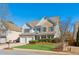 Two-story brick home with a large front yard and attached two-car garage at 4345 Settlers Grove Rd, Cumming, GA 30028