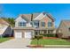 Two-story brick home with a large front yard and attached two-car garage at 4345 Settlers Grove Rd, Cumming, GA 30028