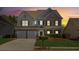 Two-story brick home with a large front yard and attached two-car garage, nighttime view at 4345 Settlers Grove Rd, Cumming, GA 30028