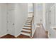 Bright foyer with hardwood floors, staircase, and coat closet at 4345 Settlers Grove Rd, Cumming, GA 30028