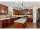 Modern kitchen with wood cabinets and granite countertops at 4345 Settlers Grove Rd, Cumming, GA 30028