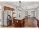 Open concept kitchen with stainless steel fridge and island at 4345 Settlers Grove Rd, Cumming, GA 30028