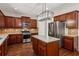 Island kitchen with stainless steel appliances and wood cabinets at 4345 Settlers Grove Rd, Cumming, GA 30028
