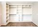 Spacious walk-in closet with built-in shelves and rods at 110 Randomwood Way, Alpharetta, GA 30022