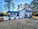 Two-story house with white siding, black shutters, and a landscaped yard at 110 Randomwood Way, Alpharetta, GA 30022