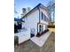 Side view of a two story house with white siding and black shutters at 110 Randomwood Way, Alpharetta, GA 30022