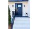 Stylish dark blue front door with sidelights and a brick stoop at 110 Randomwood Way, Alpharetta, GA 30022