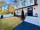 Front entrance with brick steps, black door and landscaping at 110 Randomwood Way, Alpharetta, GA 30022