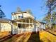 Back exterior view of a charming house with a screened porch at 110 Randomwood Way, Alpharetta, GA 30022