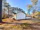 View of the side yard and house exterior, showcasing landscaping at 110 Randomwood Way, Alpharetta, GA 30022