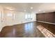 Open living room with hardwood floors and an accent wall at 110 Randomwood Way, Alpharetta, GA 30022