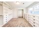 Large walk-in closet with built-in shelves and drawers at 110 Randomwood Way, Alpharetta, GA 30022