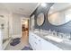 Bathroom with double vanity, shiplap wall, and large mirrors at 2418 Claude Brewer Road Rd, Loganville, GA 30052