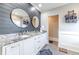 Bathroom with double vanity, shiplap wall, and large mirrors at 2418 Claude Brewer Road Rd, Loganville, GA 30052