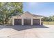 Three-car detached garage with dark brown doors at 2418 Claude Brewer Road Rd, Loganville, GA 30052