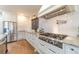 White kitchen with gas range and herringbone backsplash at 2418 Claude Brewer Road Rd, Loganville, GA 30052