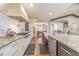 Open concept kitchen with stainless steel appliances and farmhouse sink at 2418 Claude Brewer Road Rd, Loganville, GA 30052