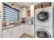 Bright laundry room with white cabinets and granite countertops at 2418 Claude Brewer Road Rd, Loganville, GA 30052