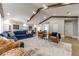 Spacious living room featuring a sectional sofa, exposed beams, and hardwood floors at 2418 Claude Brewer Road Rd, Loganville, GA 30052