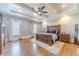 Main bedroom with hardwood floors, large bed, and tray ceiling at 2418 Claude Brewer Road Rd, Loganville, GA 30052