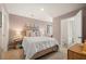 Cozy bedroom with plush carpeting, decorated with bedside tables, stylish lamps, and a view of the bathroom at 301 Sound Cir, Stockbridge, GA 30281