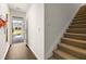 Bright entryway featuring wood floors, a coat rack, and stairs with tan carpeting at 301 Sound Cir, Stockbridge, GA 30281