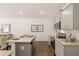 Modern kitchen with gray cabinets, granite counters, and an island at 301 Sound Cir, Stockbridge, GA 30281